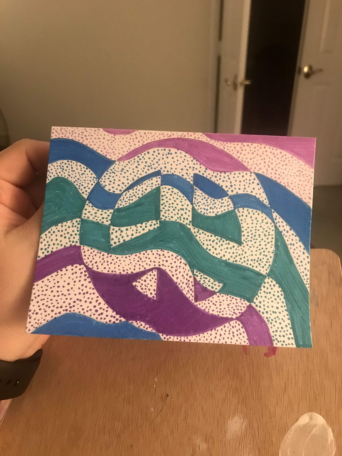 A small abstract painting in teal, purple and cream with dotted texture