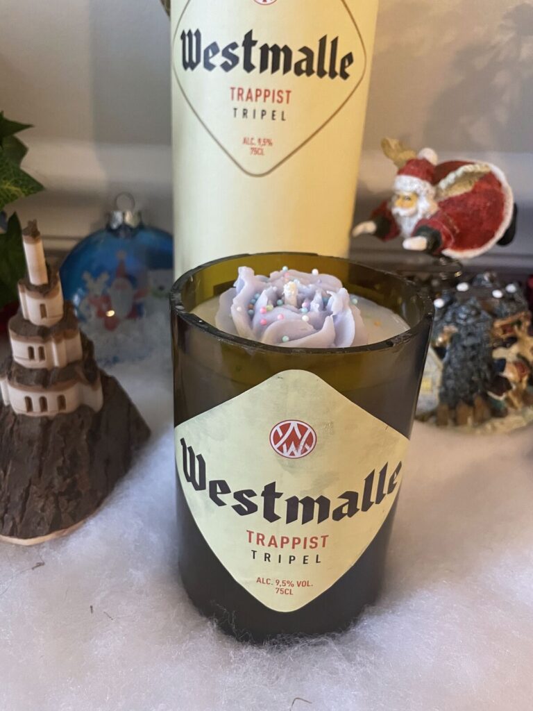 A candle poured into a cut-down beer bottle