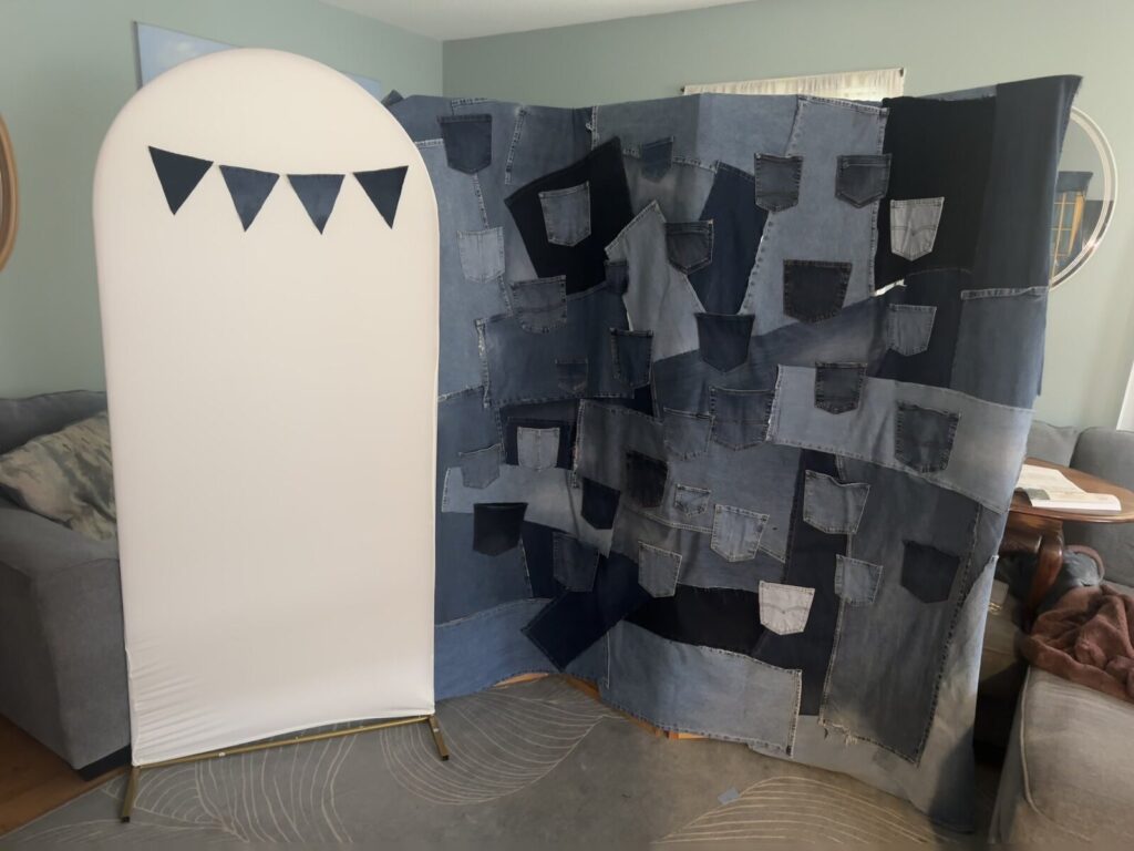 The denim patchwork panels standing on their own indoors before the balloons and bunting go up