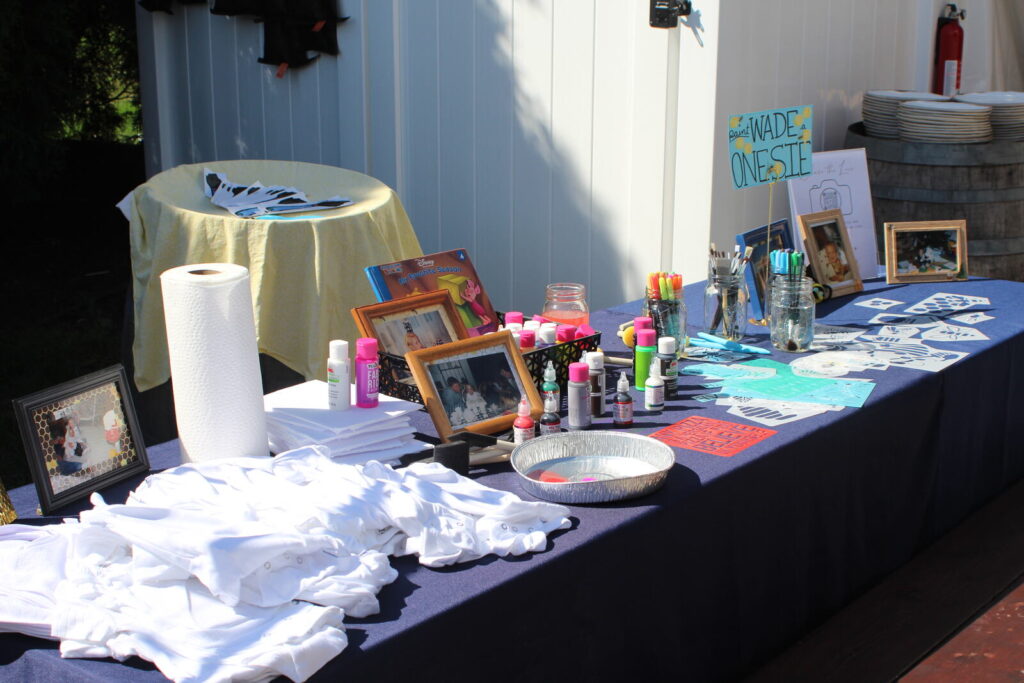 A craft activity table set up with supplies, frames and paper goods