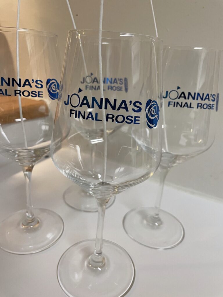 Four wine glasses with a custom bachelorette party design