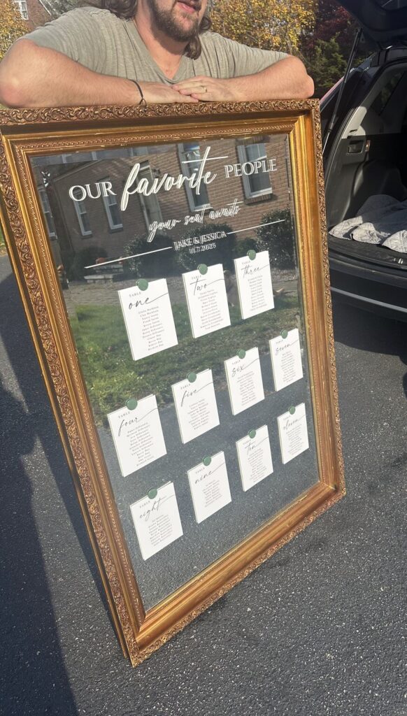 A seating chart written directly onto a mirror in white lettering