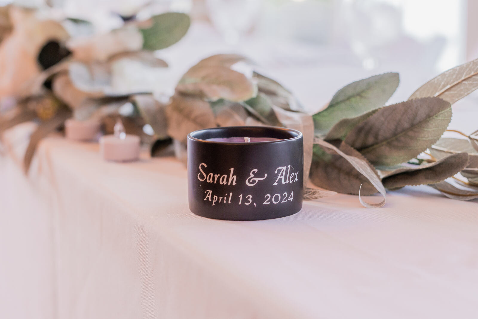 A personalised vessel at a place setting with eucalyptus and dried leaves