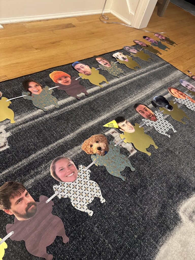 A garland strung with cut-out photographs of faces