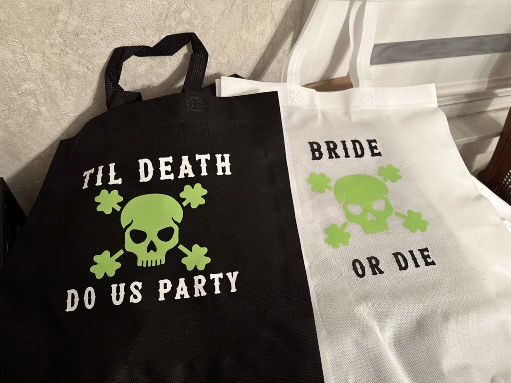 Black and white tote bags printed with bachelorette party slogans