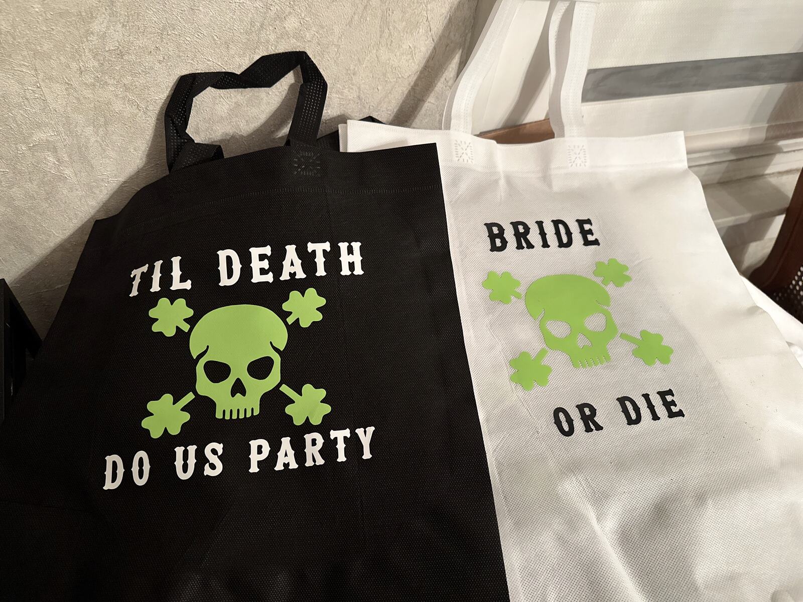 Black and white tote bags printed with bachelorette party slogans
