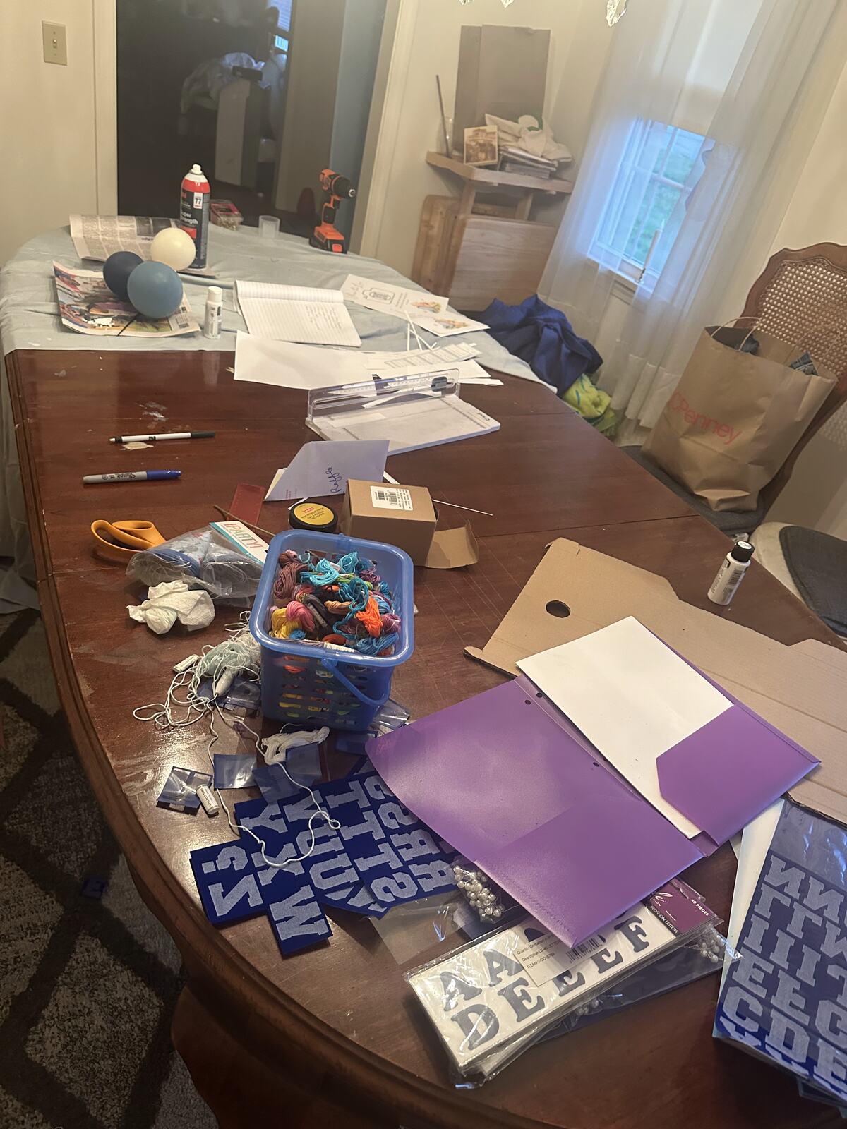 A worktable spread with vinyl sheets, tools and part-finished pieces